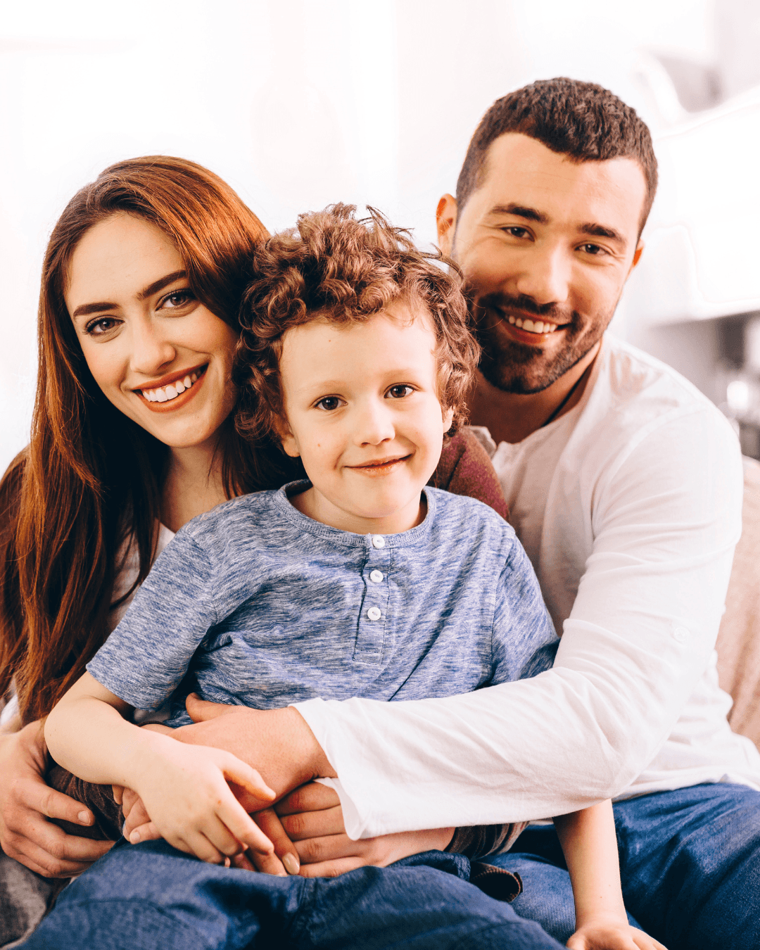 A young family embracing, representing families protected by critical illness insurance
